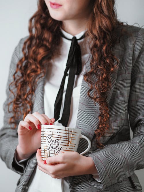 Woman in Gray Suit and with Cup