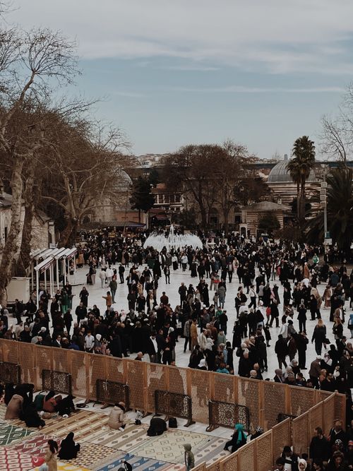 Free Large crowd congregates outside Eyup Sultan Mosque in Istanbul, Turkey during a religious gathering. Stock Photo