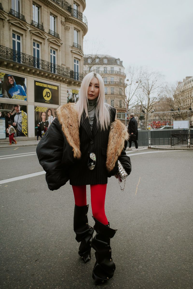 Woman in fur coat with red leggings on a Paris street