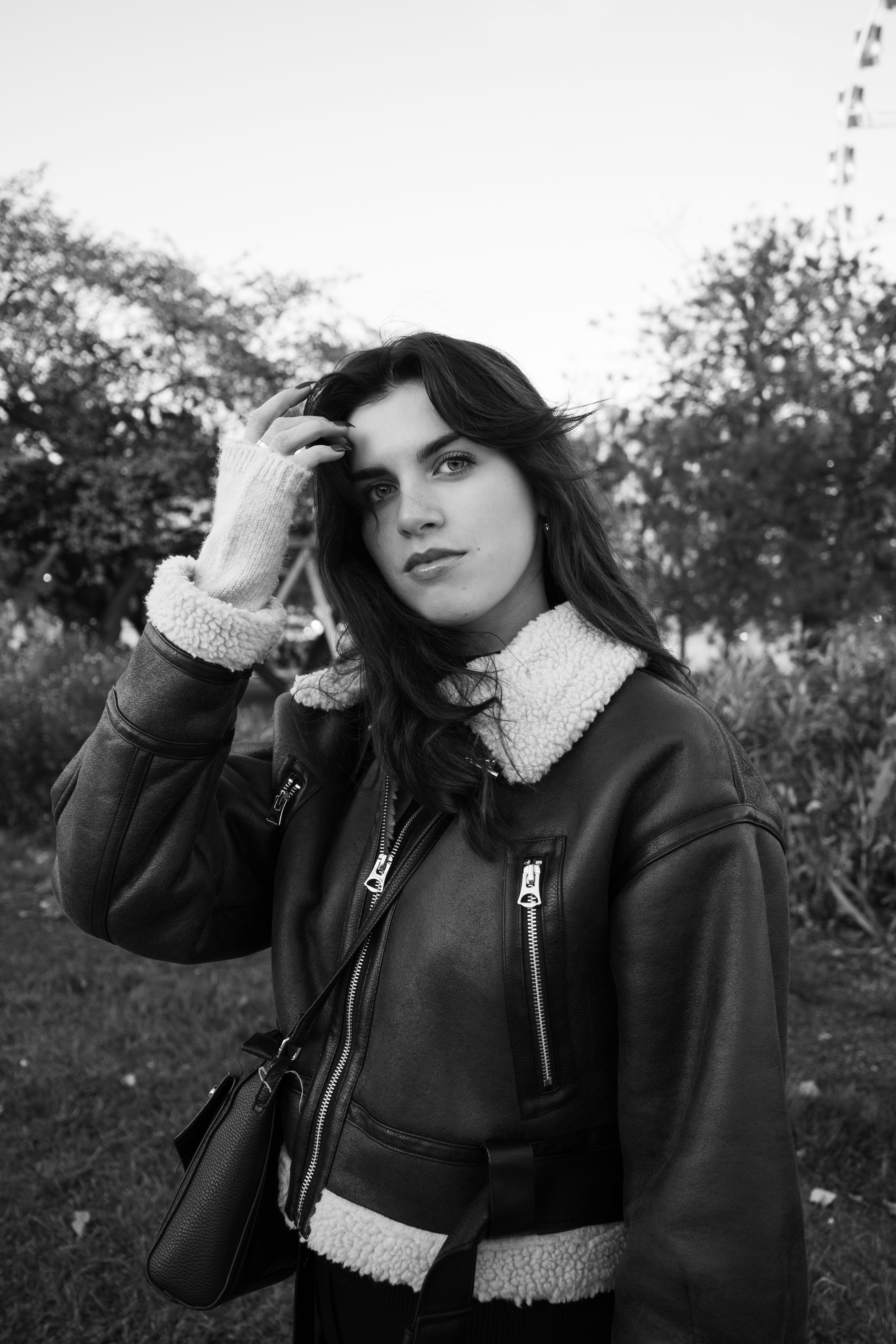 Young Woman in a Leather Jacket Standing Outside · Free Stock Photo
