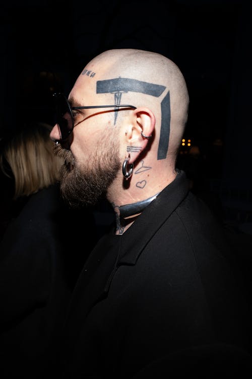 A man with a tattoo on his head and beard