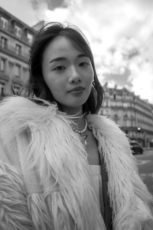 A woman in a fur coat posing for a photo