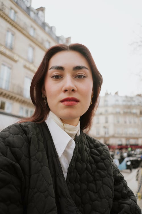 A woman with long hair and a jacket on