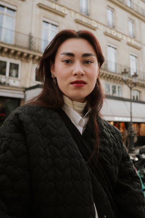 A woman in a black jacket and white shirt