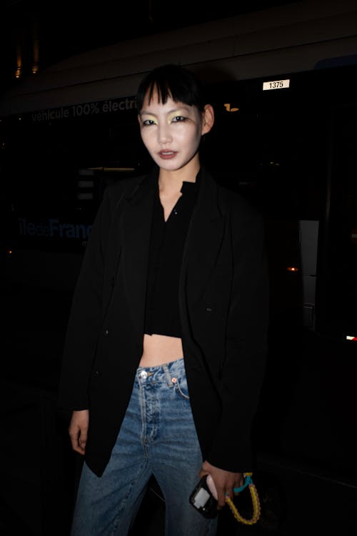 A woman in a black jacket and jeans at the airport