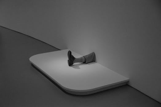 A striking minimalist art installation featuring a leg emerging from a wall in a modern museum setting.