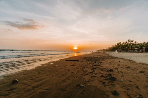 Las Lajas Beach at sunset, offering a serene coastal view with vibrant colors.