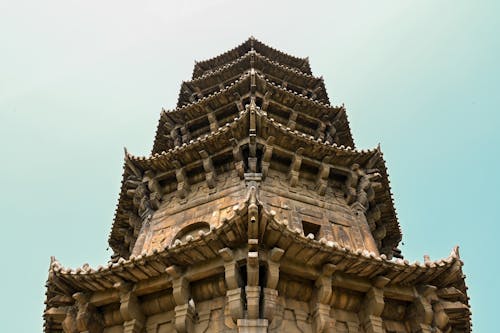 The top of a tall tower with a blue sky