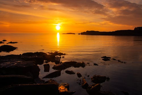 Back Lit Rocks on the Sea at Sunset