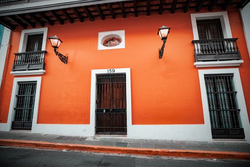 Free Vibrant orange facade of a colonial building in Old San Juan, Puerto Rico. Stock Photo