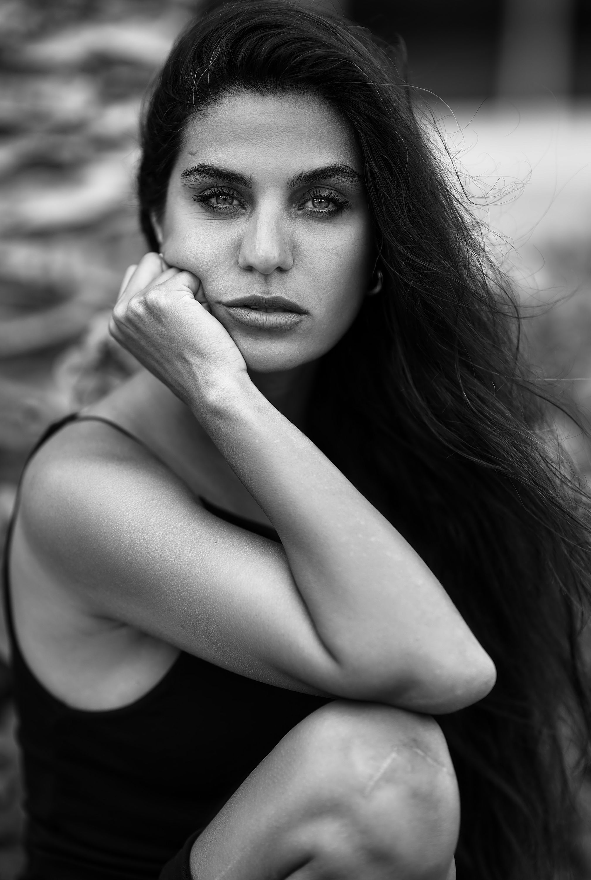 Striking black and white portrait of a woman with long hair and intense gaze.