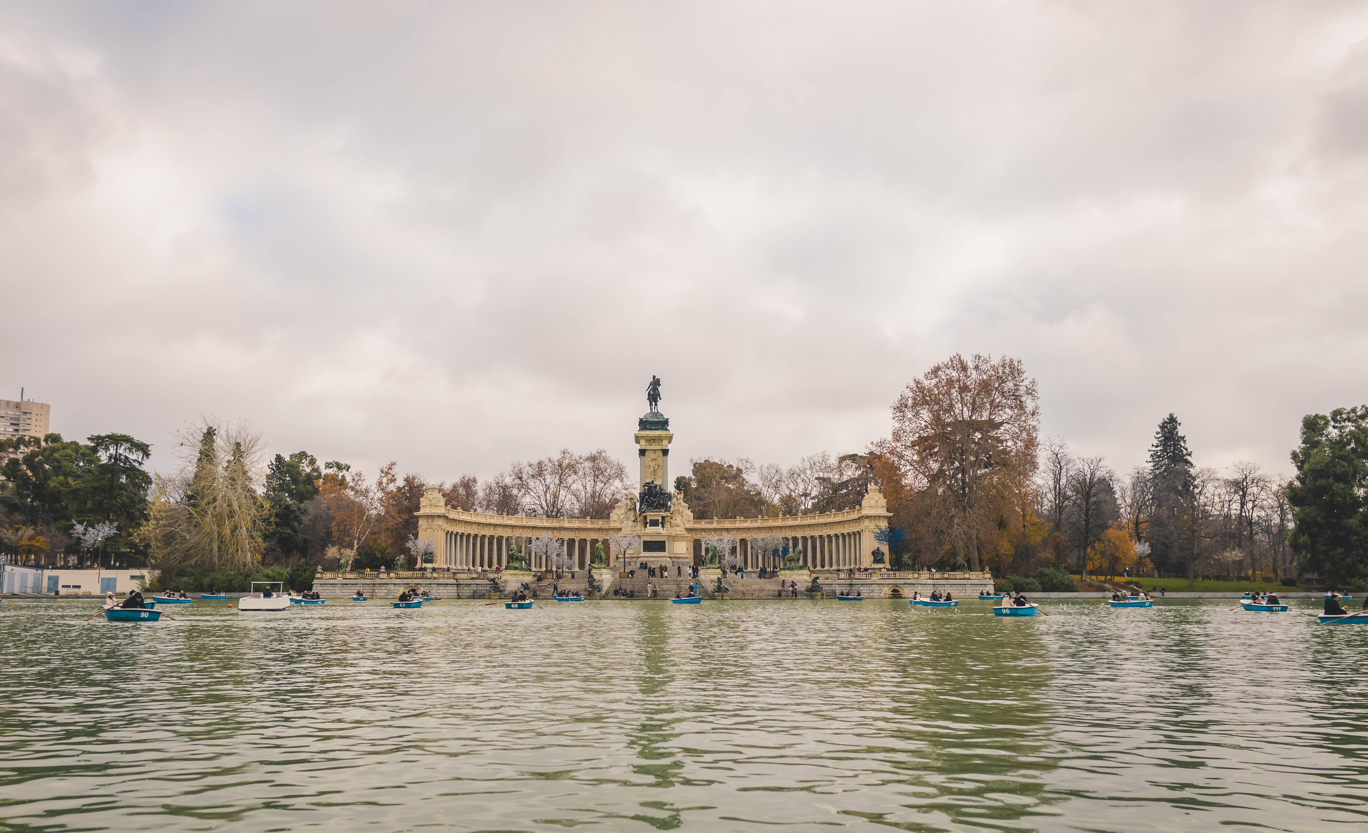 Lake and monument scene in El Retiro Park in Madrid.