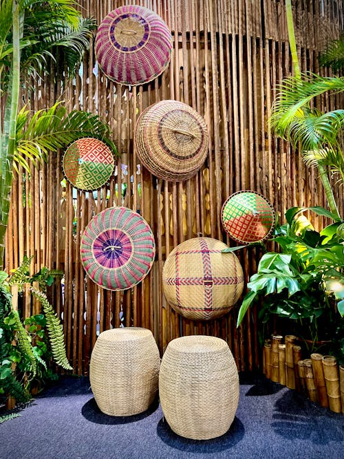 A bamboo wall with baskets and plants