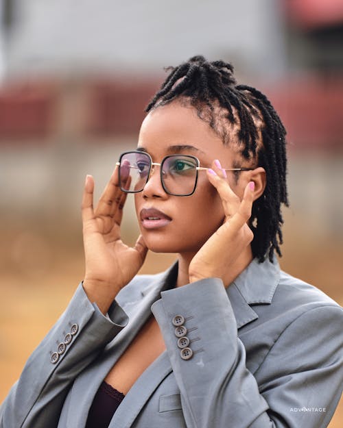 A woman with dreadlocks wearing glasses