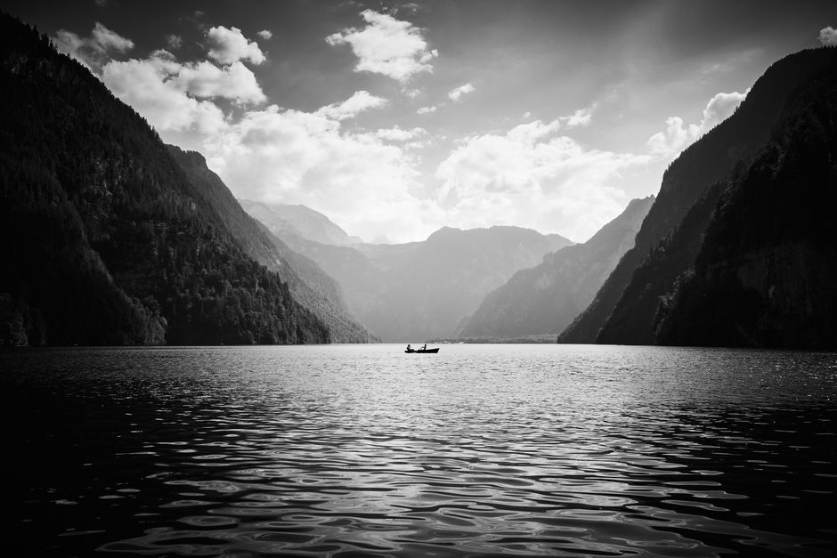 Explore the serene beauty of K枚nigssee in Bavaria, showcasing stunning mountain reflections.