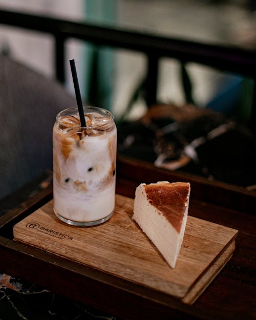 A glass of iced coffee and a slice of cake