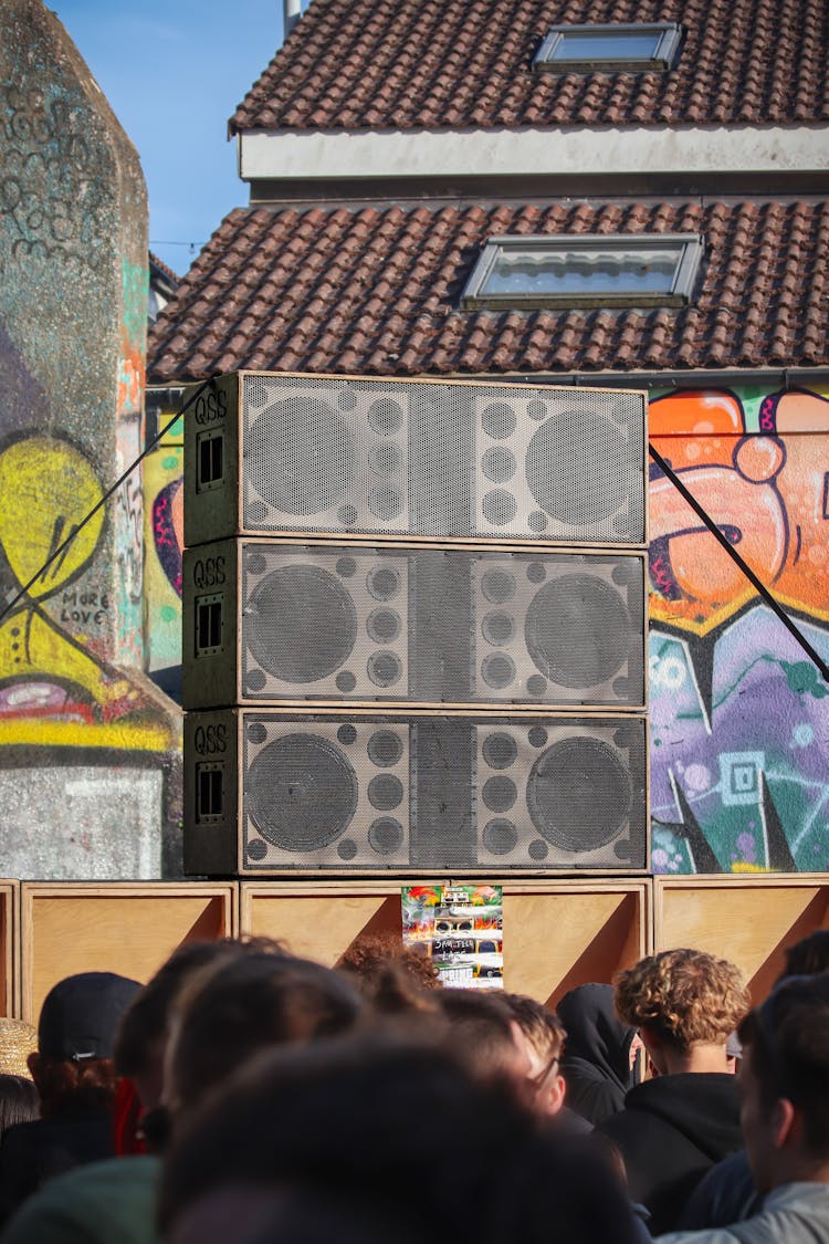 Crowd Standing In Front Of Loudspeakers At Concert