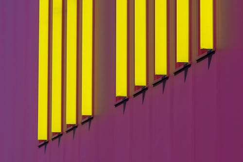 A close up of a purple and yellow building with yellow and purple stripes