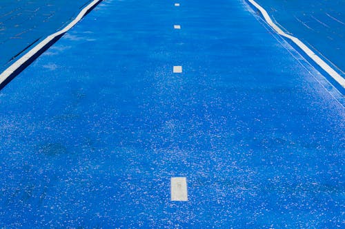 A blue track with white lines on it