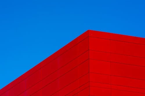 A red building with a blue sky in the background