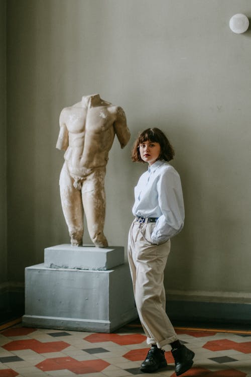Free Woman Standing Beside Sculpture Stock Photo