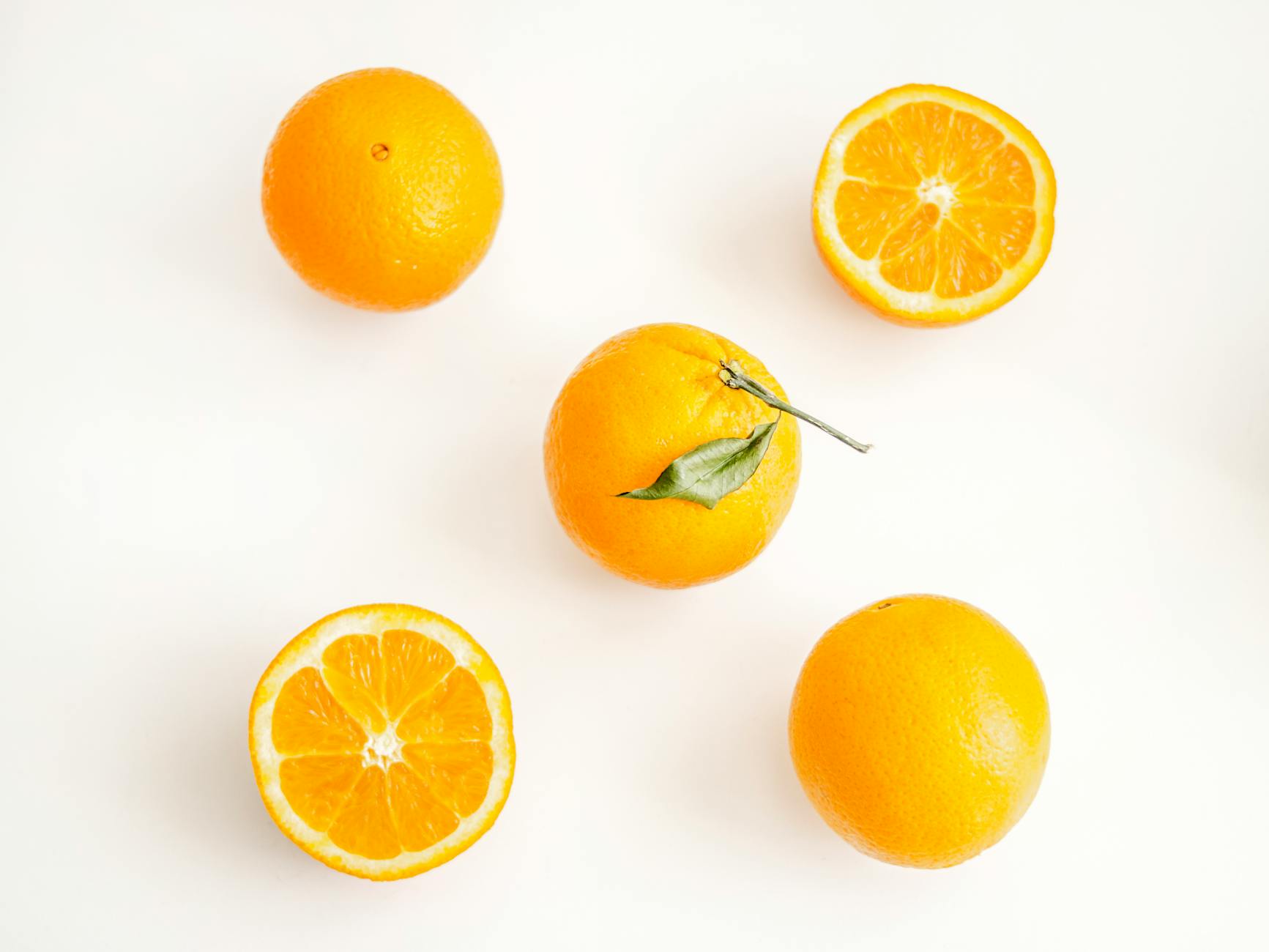 Oranges On White Surface · Free Stock Photo