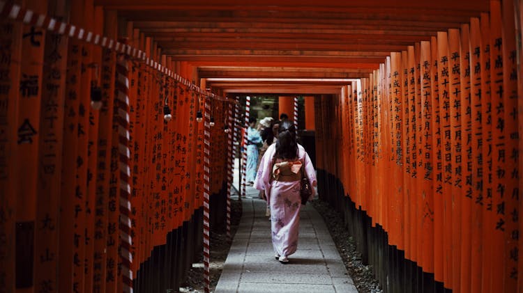 Woman Walking In Torii Gates