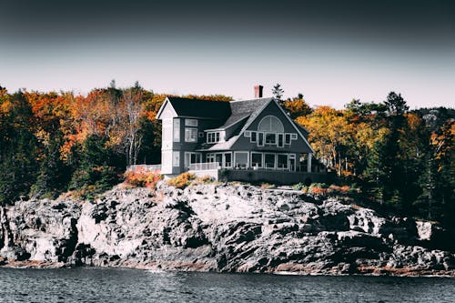 Gray and White House Beside Body of Water