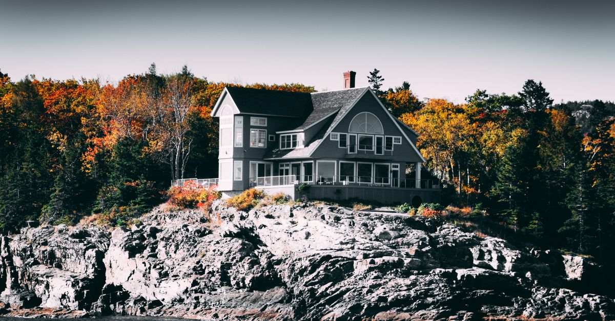 Ontario lake cottage in autumn, the kind of second home GTA families price on the purchase alone and not on carrying costs