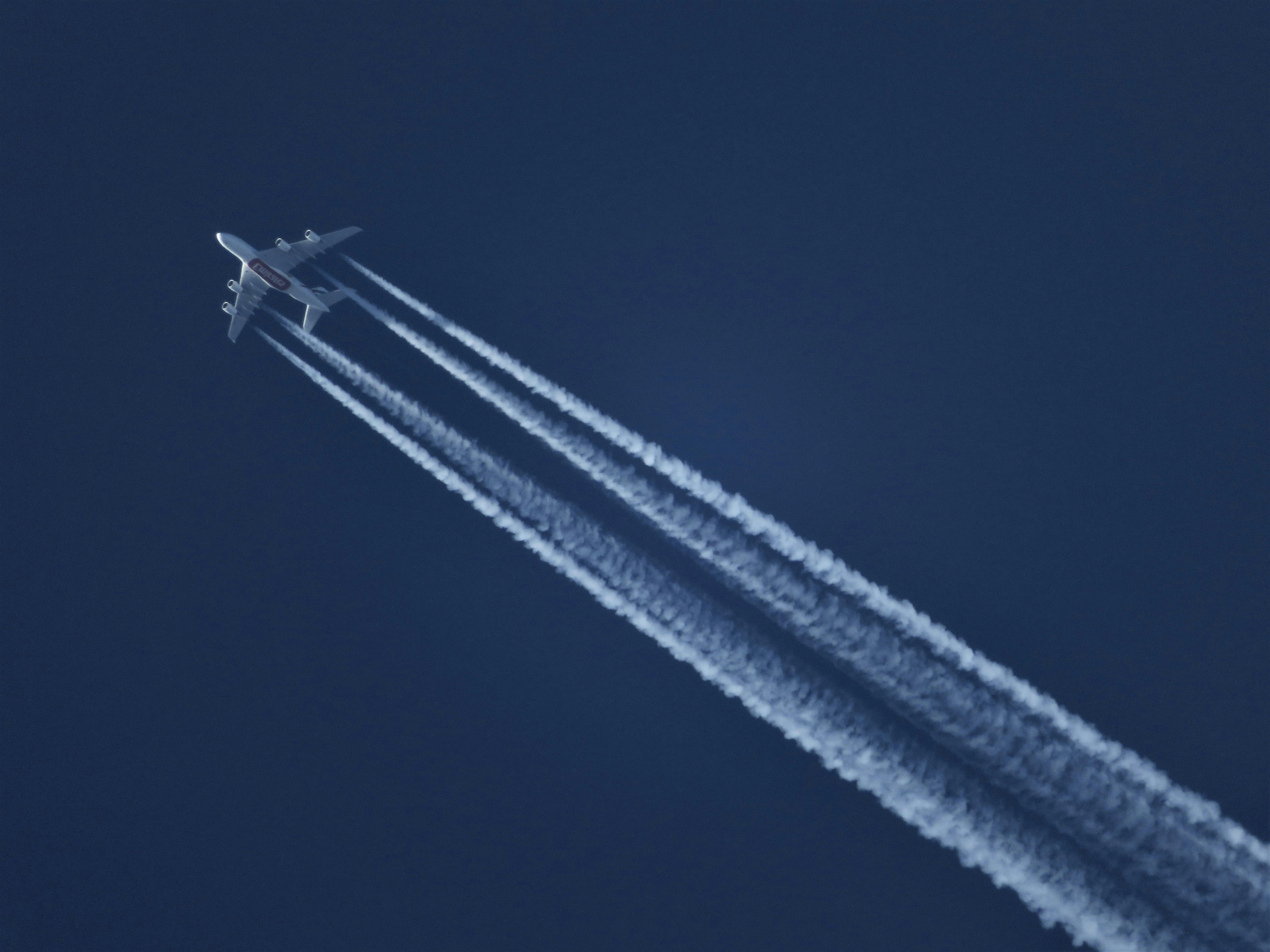 Flying Plane Leaving Contrails Free Stock Photo