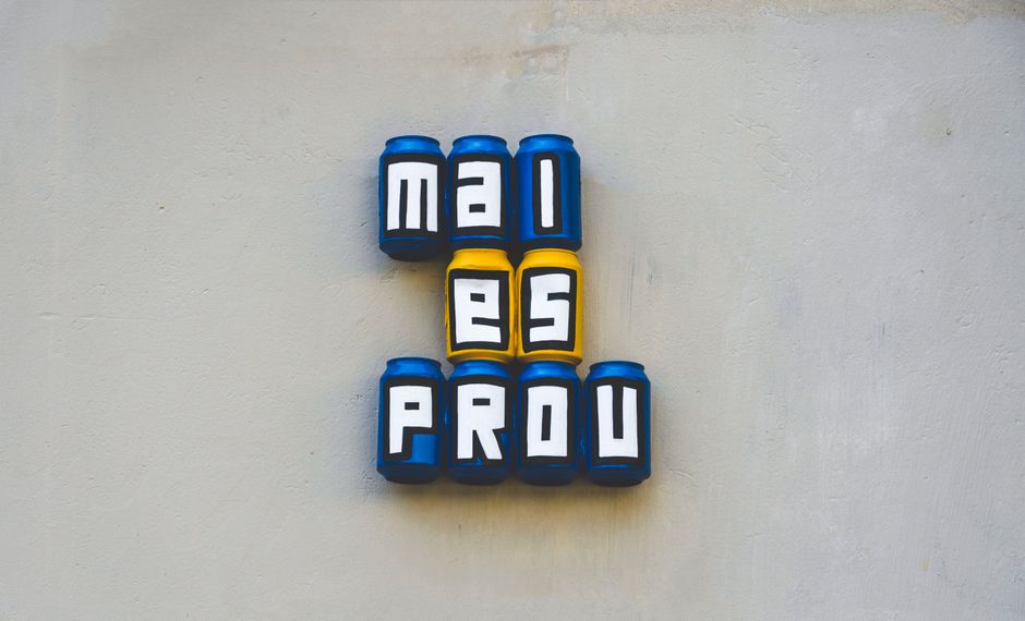 Creative wall art featuring cans spelling out words in bold colors.