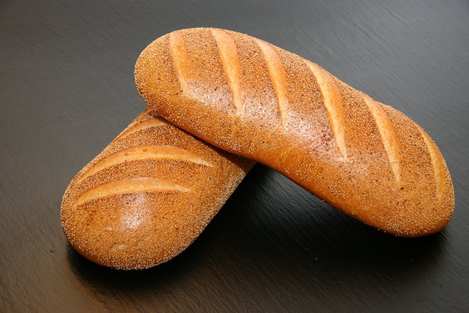Two Baked Breads on Brown Wooden Surface