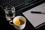 White Ceramic Cup Beside Drinking Glass