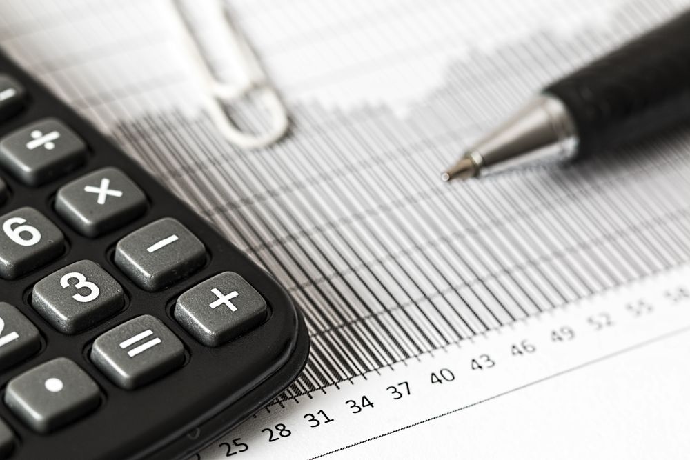 A calculator and ledger used to check invoice totals