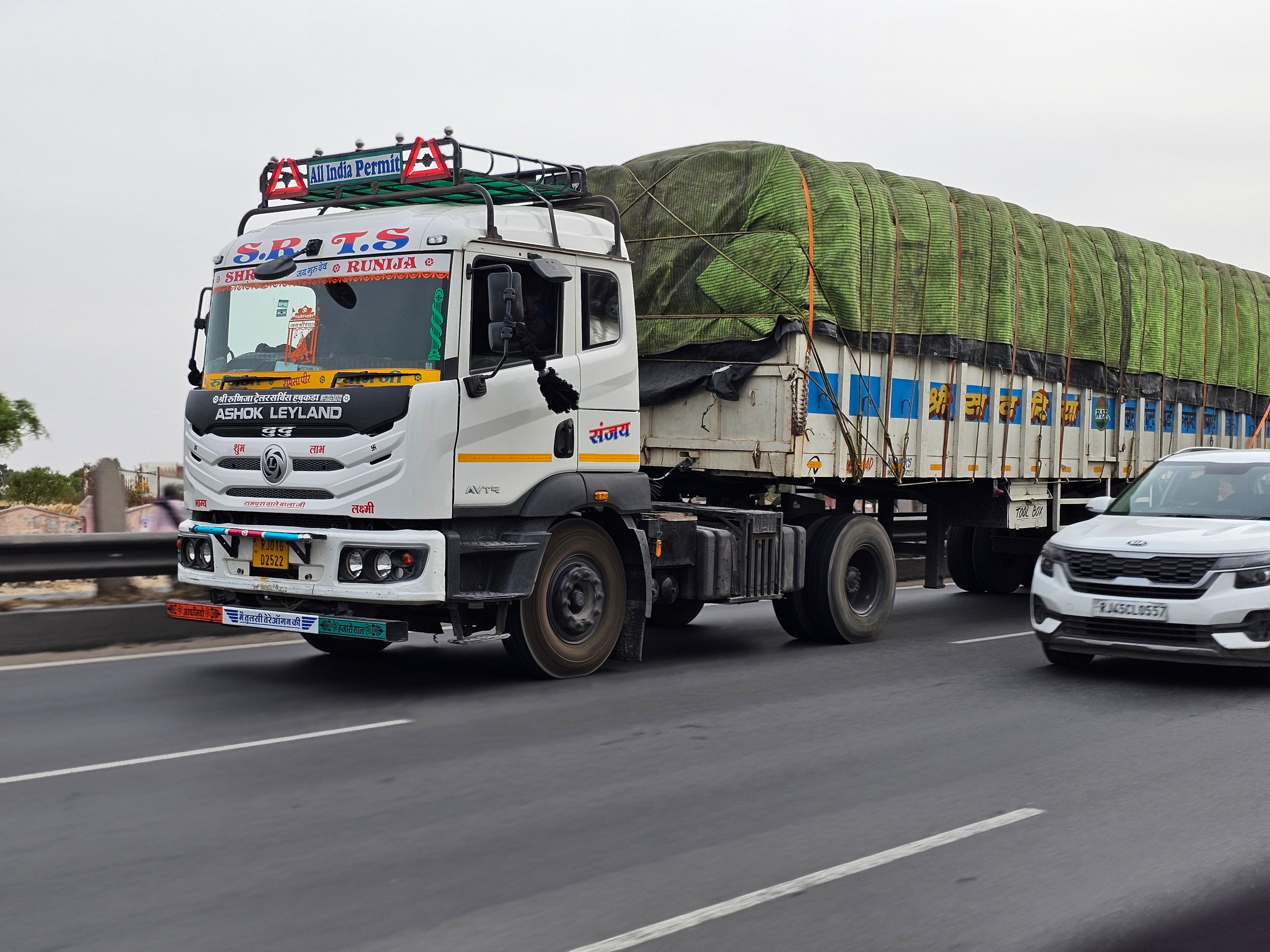 Ashok Leyland truck carrying goods on a busy Indian highway