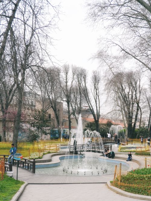 Free Beautiful urban park scene with a fountain and leisure activities in spring. Stock Photo