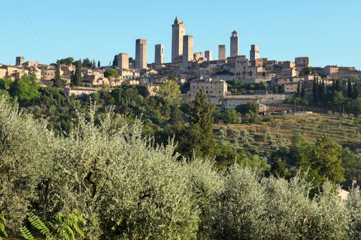 Dramatic skyline of historic San Gimignano with iconic towers amidst lush Tuscan landscape.