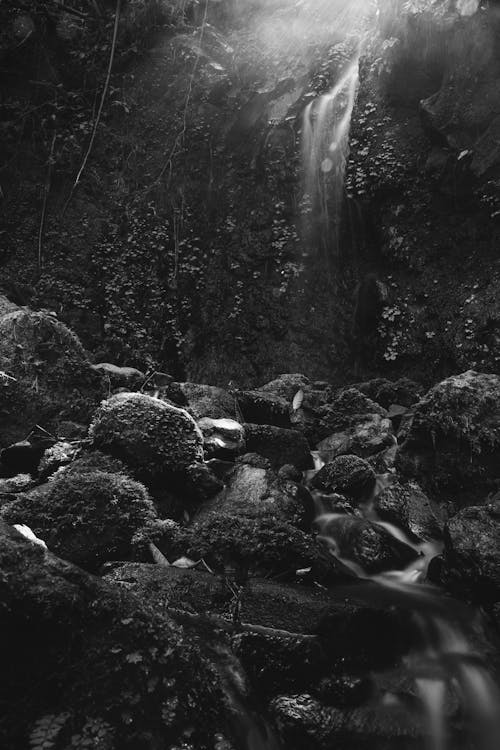 A black and white photo of a waterfall