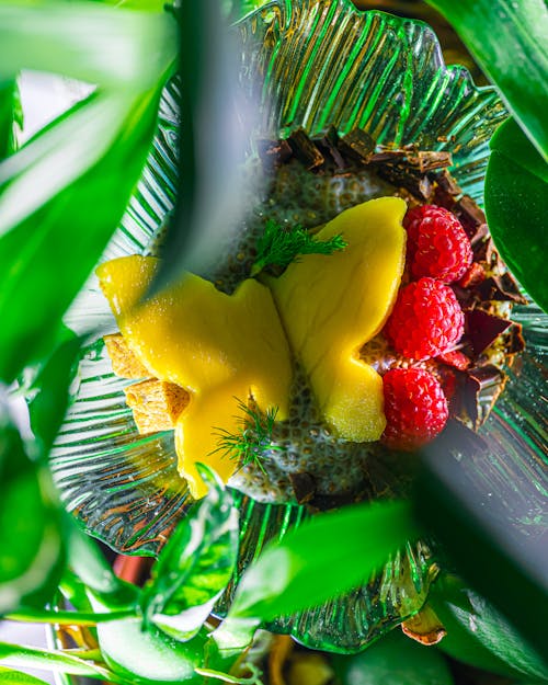 A close up of a fruit bowl with a butterfly on it