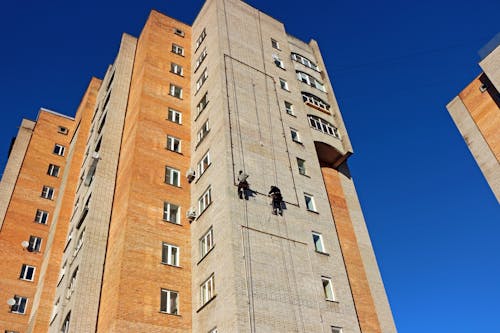 Free Person Hanging on a High Rise Building Stock Photo