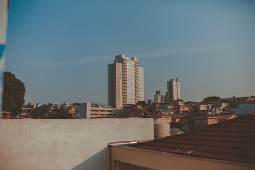Free A scenic view of a city skyline with residential high-rise buildings under a clear sky at dusk. Stock Photo