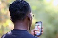 Selective Focus Photography Of Person Using Smartphone