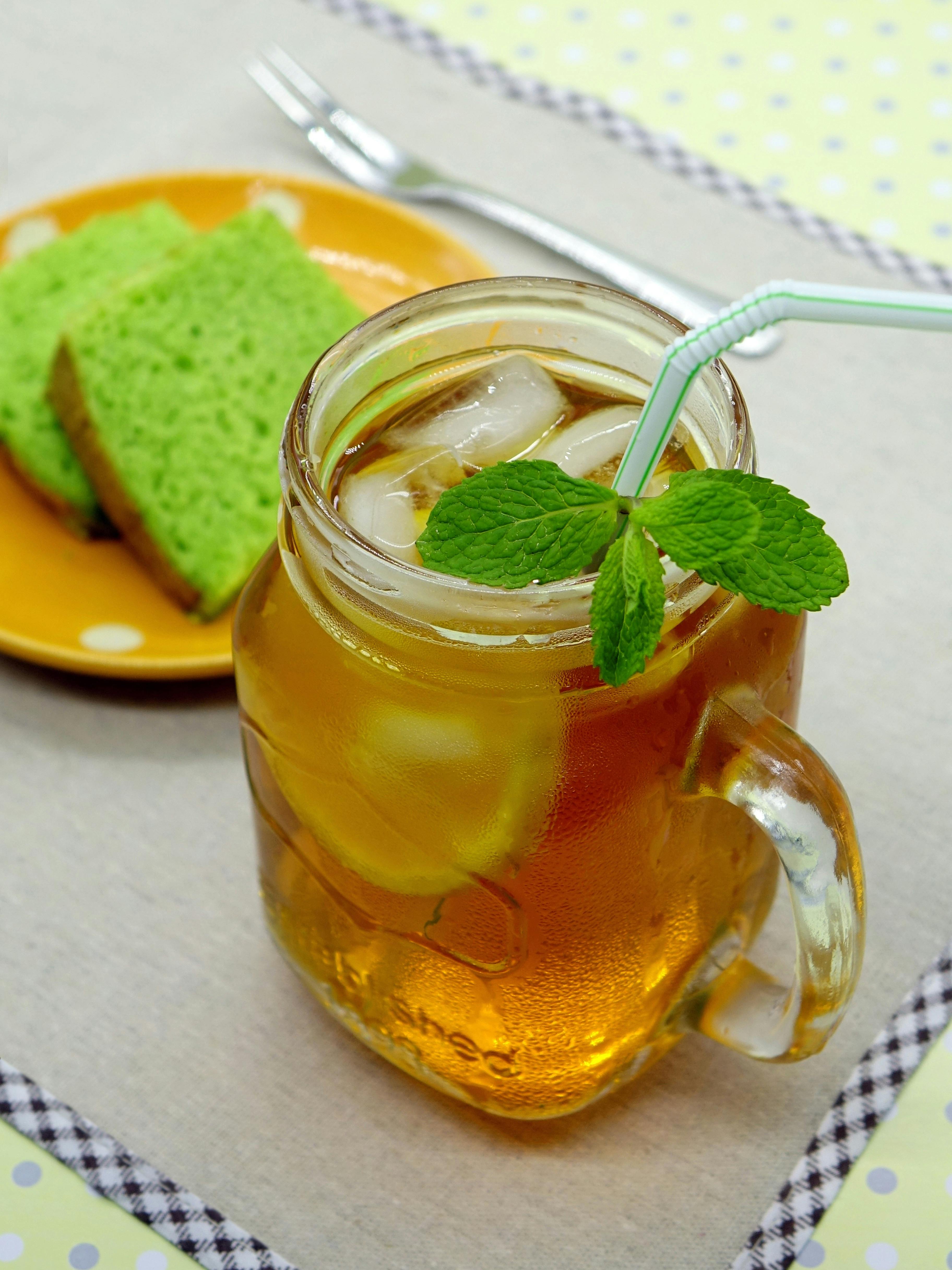 Filled Mason Jar Mug Near Brown Saucer