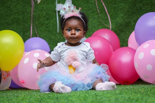 Free Toddler On A White Dress With Balloons  Stock Photo