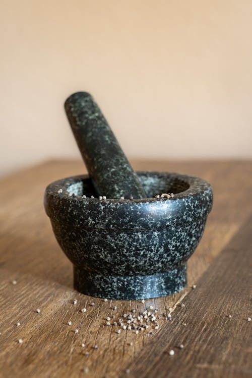 Stoneware mortar with grains on a wooden table