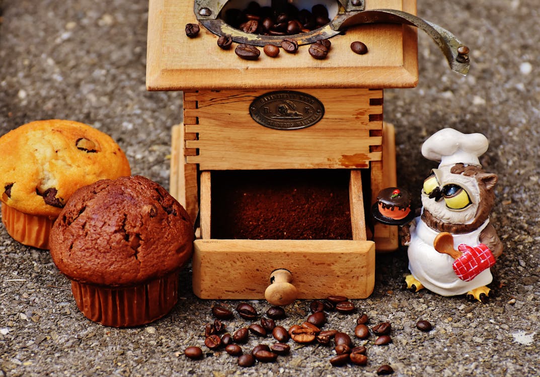 Brown Wooden Coffee Bean Grinder and Two Muffins