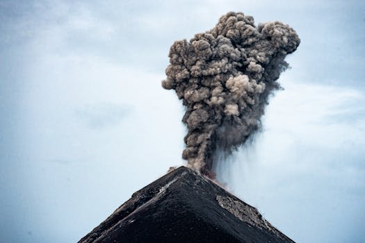 Powerful eruption of Acatenango Volcano in Guatemala with dark ash cloud and smoke.