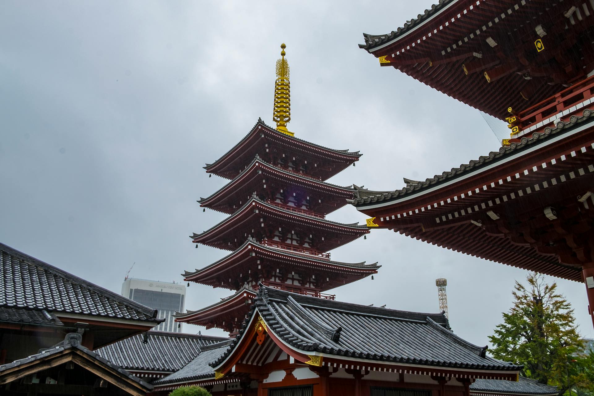 The iconic five-story pagoda at Senso-ji Temple in Tokyo, captured under cloudy skies, showcasing traditional Japanese architecture.