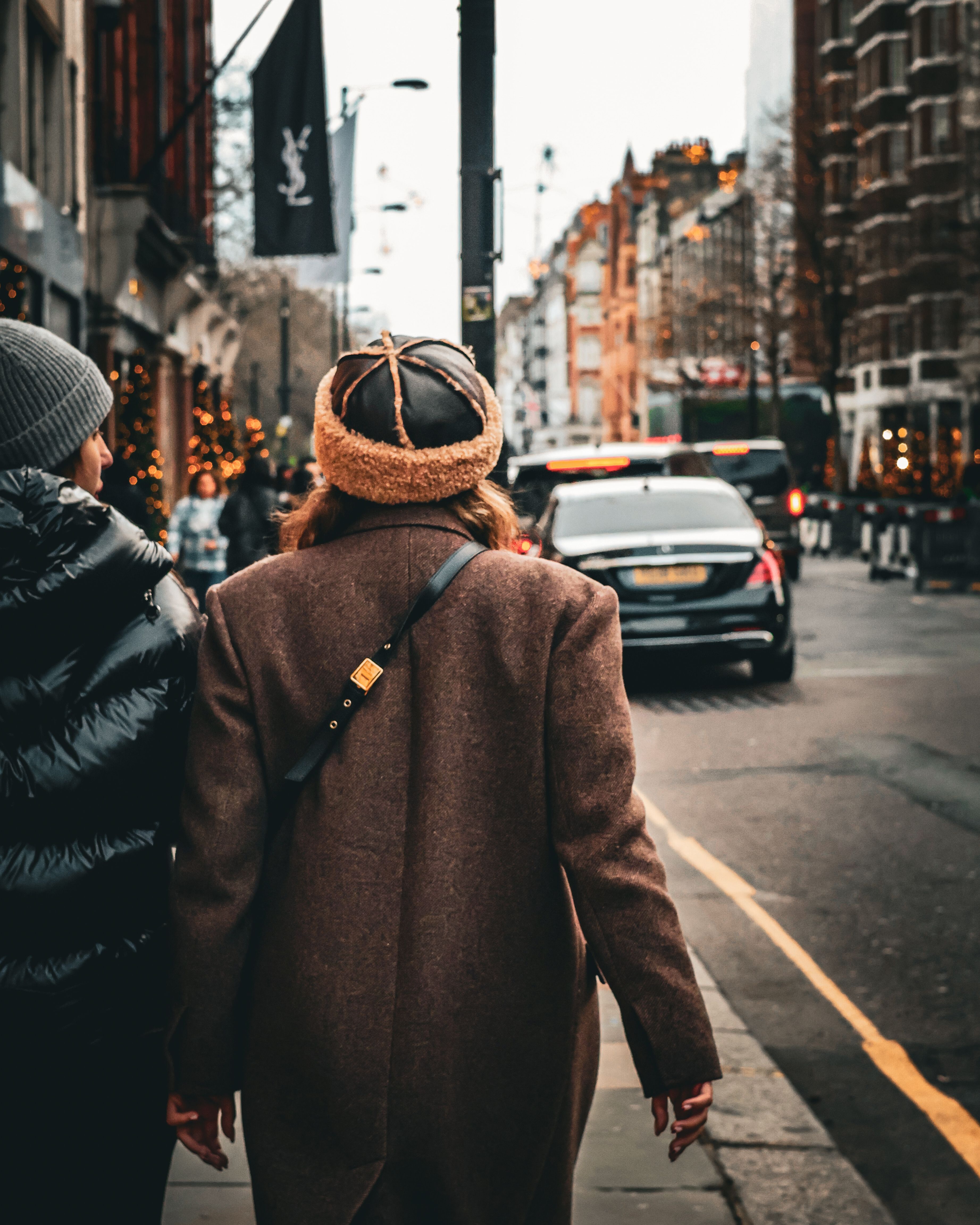 Woman in Hat and Brown Coat on Sidewalk · Free Stock Photo