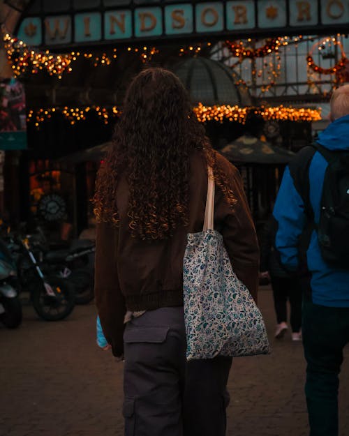 A woman walking down a street with a bag